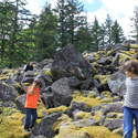 kids on mossy boulder slope